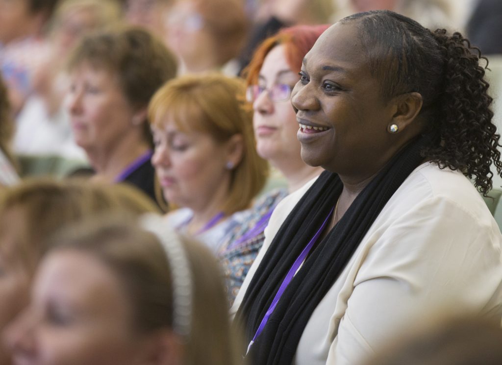 Smiling audience participant at the QNI 2016 conference